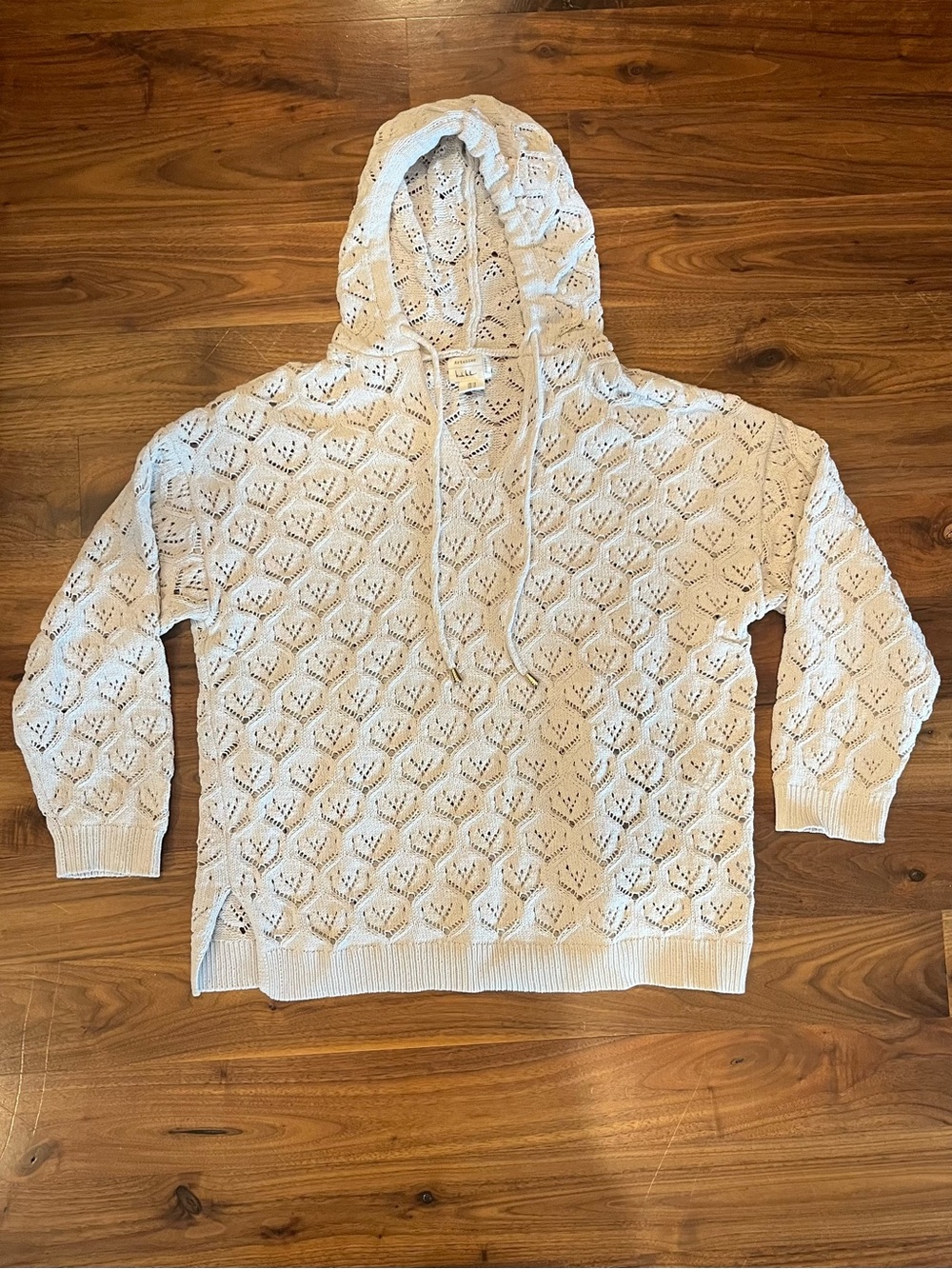Cream colored sweater-hoodie by Nicole Miller from her “Atelier” line